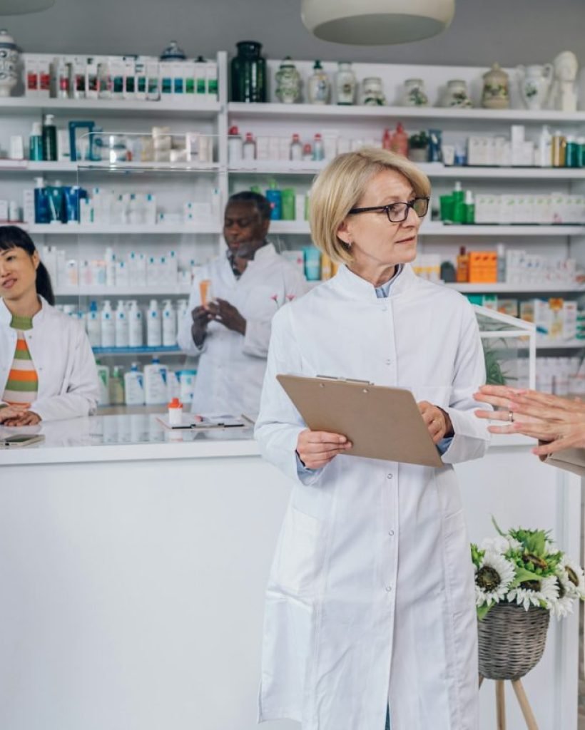 senior-pharmacist-talking-with-a-customer-in-a-pharmacy.jpg